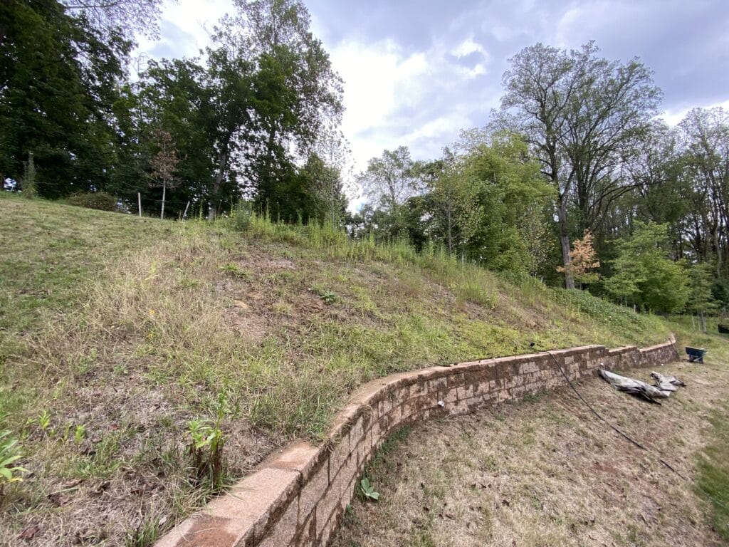 A before image of the slope with crew in the beginning stage of removal A before image of the slope with crew in the beginning stage of removal
